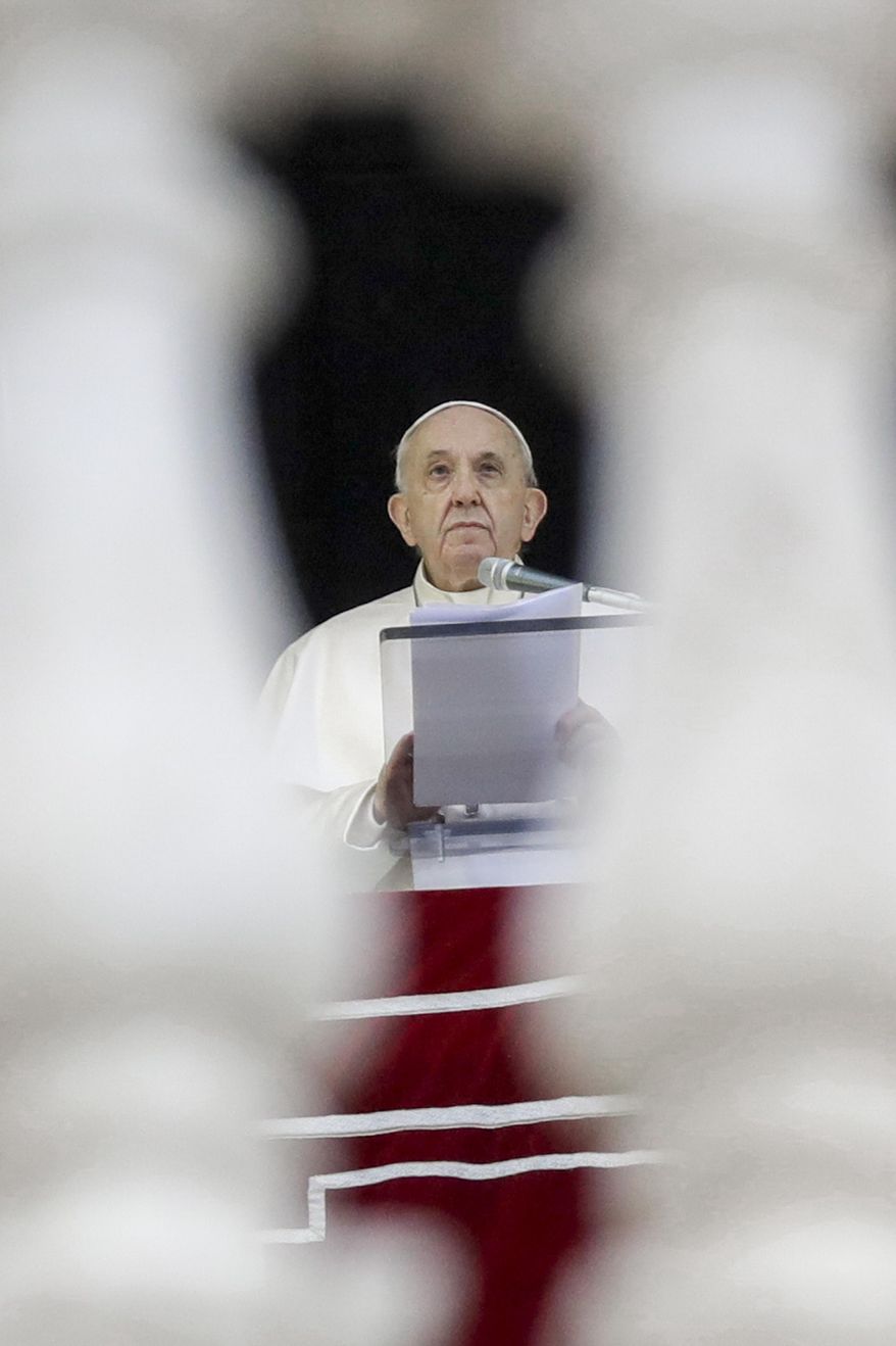 Pope Francis recites the Angelus noon prayer from the window of his studio overlooking St.Peter's Square, at the Vatican, Sunday, Dec. 6, 2020. (AP Photo/Andrew Medichini)