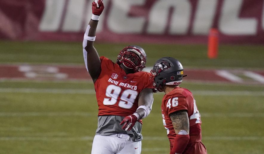 New Mexico nose tackle Ben Gansallo (99) celebrates after making a sack against Wyoming during the second half of an NCAA college football game Saturday, Dec. 5, 2020, in Las Vegas. (AP Photo/John Locher)