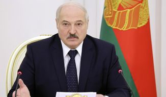 Belarusian President Alexander Lukashenko attends a meeting on the work of the economy in the current year in Minsk, Belarus, Monday, Dec. 7, 2020. (Maxim Guchek/BelTA Pool Photo via AP)