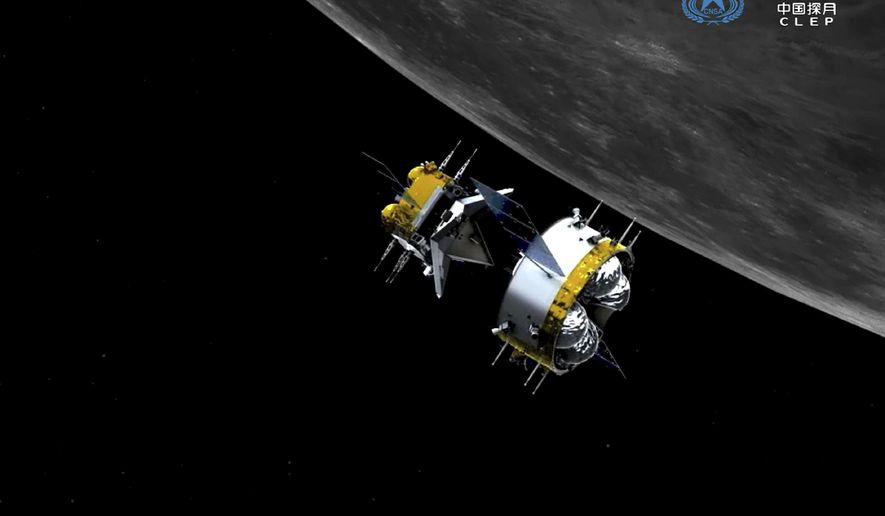 This graphic simulation image provided by China National Space Administration shows the orbiter and returner combination of China's Chang'e-5 probe after its separation from the ascender, at the Beijing Aerospace Control Center (BACC) in Beijing Sunday, Dec. 6, 2020. The Chinese probe that landed on the moon transferred rocks to an orbiter Sunday in preparation for returning samples of the lunar surface to Earth for the first time in almost 45 years, the country's space agency announced. (China National Space Administration/Xinhua via AP)