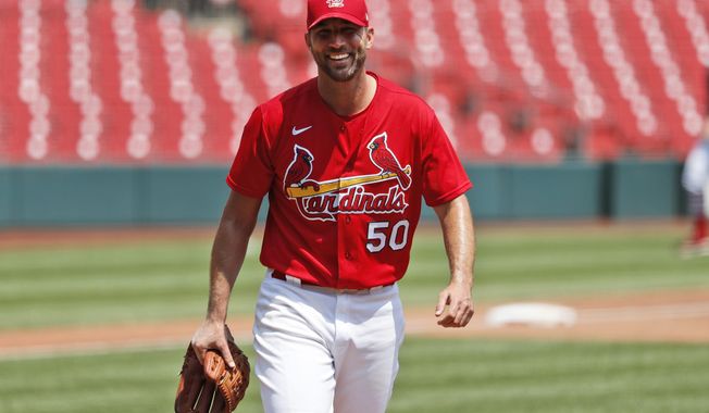 FILE - St. Louis Cardinals pitcher Adam Wainwright smiles after throwing a simulated inning during baseball practice at Busch Stadium in St. Louis, in this Sunday, July 5, 2020, file photo. Longtime St. Louis Cardinals pitcher Adam Wainwright has won the Roberto Clemente Award, given annually by Major League Baseball for community involvement and philanthropy. (AP Photo/Jeff Roberson, File)