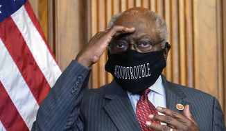 In this Sept. 17, 2020, file photo, House Majority Whip James Clyburn of South Carolina shields his eyes from a television light to look at a reporter asking a question during a news conference with House Speaker Nancy Pelosi on Capitol Hill. Clyburn and other Democrats blamed rhetoric about defunding local police departments for the party’s surprise loss of seats in the House. (AP Photo/Jacquelyn Martin, File)