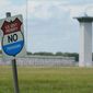 In this Aug. 28, 2020, file photo, a no trespassing sign is displayed outside the federal prison complex in Terre Haute, Ind. (AP Photo/Michael Conroy, File)  **FILE**