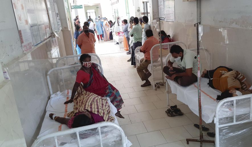 Patients and their bystanders are seen at the district government hospital in Eluru, Andhra Pradesh state, India, Sunday, Dec.6, 2020. Over 200 people have been hospitalized due to an unidentified illness in this ancient city famous for its hand woven products. (AP Photo)