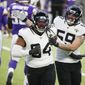 Jacksonville Jaguars defensive end Dawuane Smoot (94) celebrates with teammate Aaron Lynch (59) after a sack during the first half of an NFL football game against the Minnesota Vikings, Sunday, Dec. 6, 2020, in Minneapolis. (AP Photo/Bruce Kluckhohn)