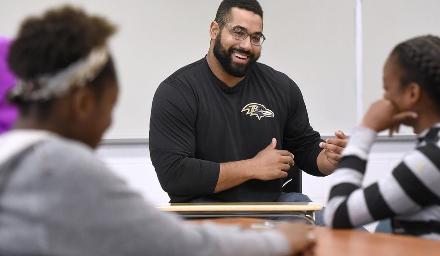 FILE - Baltimore Ravens lineman and math scholar John Urschel teaches a lesson at Dundalk High School to launch Texas Instruments&#39; STEM Behind Cool Careers series in Baltimore, in this Tuesday, July 18, 2017, file photo.  John Urschel has found that a master&#39;s degree in mathematics, his stature as an accomplished author and his pending PhD at MIT isn&#39;t necessarily enough to sell young students on the benefit of crunching numbers.What really makes him interesting to most kids is that he&#39;s a former NFL player who opted to immerse himself in math. (Steve Ruark/AP Images for Texas Instruments, File)