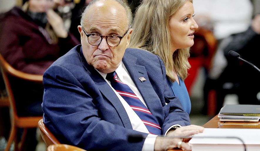 Rudy Giuliani, President Donald Trump&#39;s personal attorney, scans the room during a Michigan House Oversight Committee hearing for suspicion of voter fraud within the state at the House Office Building in Lansing, Mich., on Wednesday, Dec. 2, 2020. (Mike Mulholland/The Grand Rapids Press via AP)