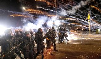 In this file photo, police use chemical irritants and crowd control munitions to disperse protesters during a demonstration in Portland, Ore., Saturday, Sept. 5, 2020. (AP Photo/Noah Berger, File)  **FILE**
