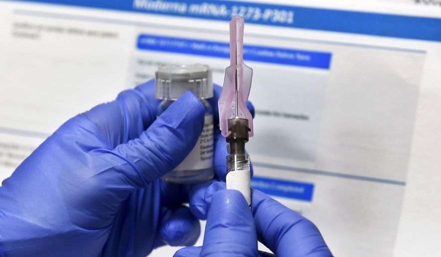 In this Monday, July 27, 2020, file photo, a nurse prepares a syringe during a study of a possible COVID-19 vaccine, developed by the National Institutes of Health and Moderna Inc., in Binghamton, N.Y. (AP Photo/Hans Pennink)