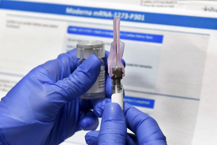 In this Monday, July 27, 2020, file photo, a nurse prepares a syringe during a study of a possible COVID-19 vaccine, developed by the National Institutes of Health and Moderna Inc., in Binghamton, N.Y. (AP Photo/Hans Pennink)