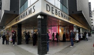 People queue up waiting for the Debenhams department store, which is expected to close down, to open for the day&#39;s trading as non-essential shops are allowed to reopen after England&#39;s second lockdown ended at midnight, on Oxford Street, in London, Wednesday, Dec. 2, 2020. In another dark day for the British retailing industry, Debenhams said Tuesday it will start liquidating its business after a potential buyer of the company pulled out, a move that looks like it will cost 12,000 workers their jobs. (AP Photo/Matt Dunham)