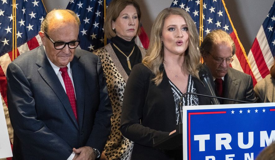 Members of President Donald Trump&#x27;s legal team, including former Mayor of New York Rudy Giuliani, left, Sidney Powell, and Jenna Ellis, speaking, attend a news conference at the Republican National Committee headquarters, Thursday Nov. 19, 2020, in Washington. (AP Photo/Jacquelyn Martin) **FILE**
