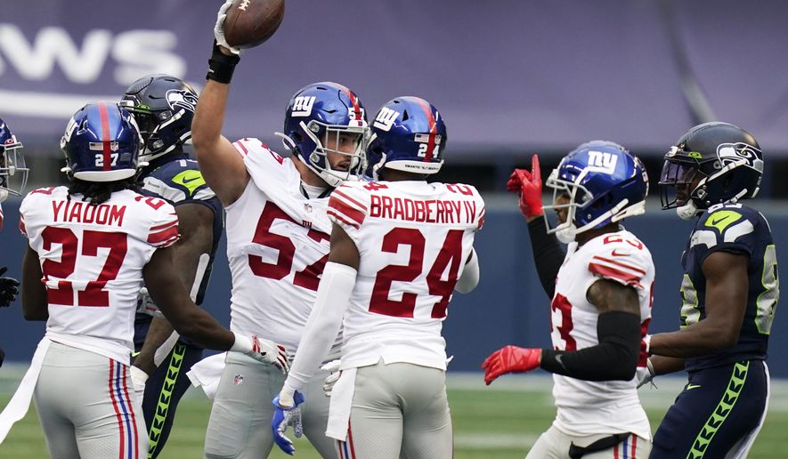 New York Giants defensive end Niko Lalos (57) celebrates with teammates after he recovered a fumble by Seattle Seahawks quarterback Russell Wilson (not shown) during the first half of an NFL football game, Sunday, Dec. 6, 2020, in Seattle. (AP Photo/Elaine Thompson)