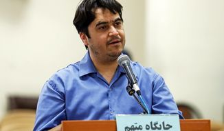 In this June 2, 2020 photo, journalist Ruhollah Zam speaks during his trial at the Revolutionary Court, in Tehran, Iran. Iran. The judiciary spokesman, Gholamhossein Esmaili, announced Tuesday, June 30, 2020 that Zam, a journalist whose online work helped inspire the 2017 economic protests and who returned from exile to Tehran was sentenced to death. The Persian writing on the podium reads, &amp;quot;defendant&#39;s place.&amp;quot; (Ali Shirband/Mizan News Agency via AP)