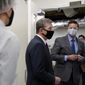 Gov. Roy Cooper, center, is seen during a tour of Gilero in Pittsboro, N.C., Thursday, Dec. 3, 2020. The medical device manufacturer began producing face shields when the pandemic started and also produces swabs for rapid tests in addition to self contained oxygenated negative pressure environments. (AP Photo/Gerry Broome)