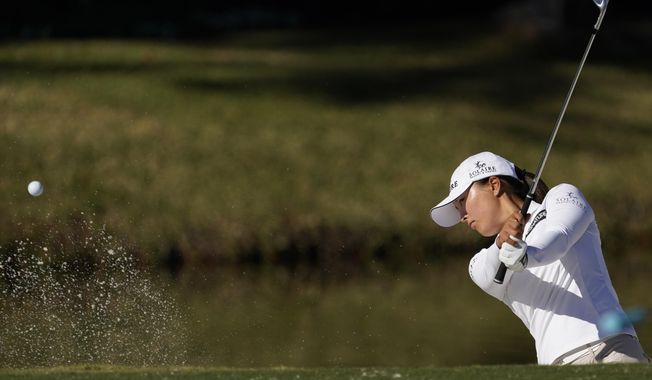 Jin Young Ko, of Korea, hits out of a bunker on the 11th hole during a practice round at the U.S. Women&#x27;s Open golf championship Tuesday, Dec. 8, 2020, in Houston.(AP Photo/David J. Phillip)