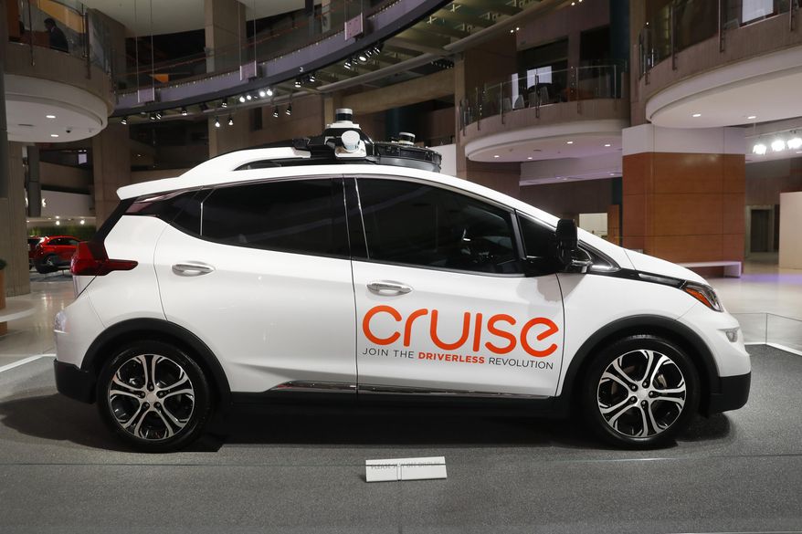 FILE - In this Jan. 16, 2019, file photo, Cruise AV, General Motor's autonomous electric Bolt EV is displayed in Detroit. General Motors' self-driving car company is sending vehicles without anybody behind the wheel in San Francisco as it navigates its way toward launching a robotic taxi service that would compete against Uber and Lyft in the hometown of the leading ride-hailing services. The move announced Wednesday, Dec. 9, 2020, by GM-owned Cruise come two months after the company received California’s permission to fully driverless cars in the state. (AP Photo/Paul Sancya, File)