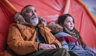 This image released by Netflix shows Caoilinn Springall, right, and George Clooney in a scene from &amp;quot;The Midnight Sky.&amp;quot; (Philippe Antonello/Netflix via AP)
