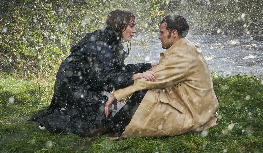 This image released by Bleecker Street shows Jamie Dornan, right, and Emily Blunt in a scene from "Wild Mountain Thyme." (Kerry Brown/Bleecker Street via AP)