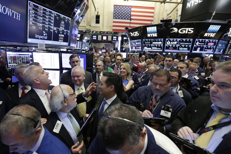 FILE - New York Stock Exchange floor governor Rudy Maas, left, calls out prices during the IPO of MGM Growth Properties on the floor of the NYSE, Wednesday, April 20, 2016. Wall Street has rolled out the welcome mat for companies going public this year, boosting proceeds from initial public offerings to the highest level in six years. Companies that have gone public this year have averaged a return of 53.8% above their IPO price, including a return of 23.4% after their first day of trading, according to Renaissance Capital, an IPO research provider. (AP Photo/Richard Drew, file)