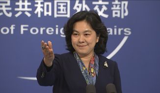 China&#x27;s Foreign Ministry spokesperson Hua Chunying gestures during a press conference held at the Foreign Ministry in Beijing on Thursday, Dec. 10, 2020. China is imposing restrictions on travel to Hong Kong by some U.S. officials and others in retaliation for similar measures imposed on Chinese individuals by Washington, the Foreign Ministry said Thursday. (AP Photo/Liu Zheng)