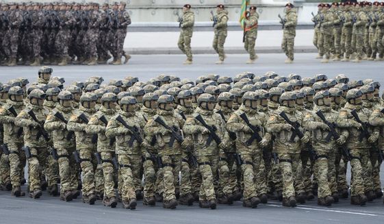 Azerbaijani troops march past during a parade in Baku, Azerbaijan, Thursday, Dec. 10, 2020. A military parade has been held in the Azerbaijani capital in celebration of a peace deal with Armenia over Nagorno-Karabakh that saw Azerbaijan reclaim much of the separatist region along with surrounding areas.  (AP Photo)