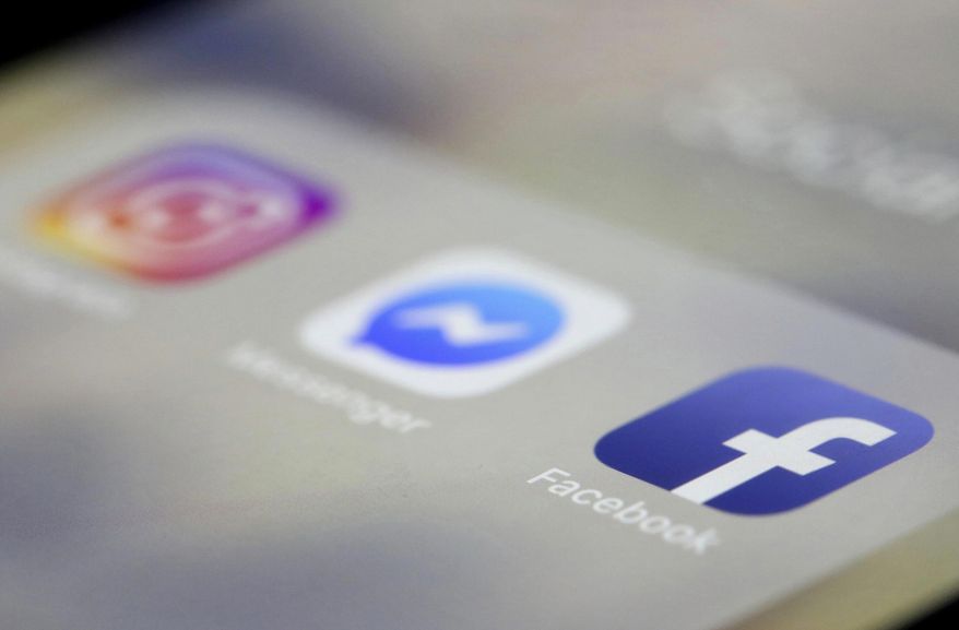 In this March 13, 2019, photo, Instagram, Messenger and Facebook apps are displayed on an iPhone in New York. (AP Photo/Jenny Kane) **FILE**