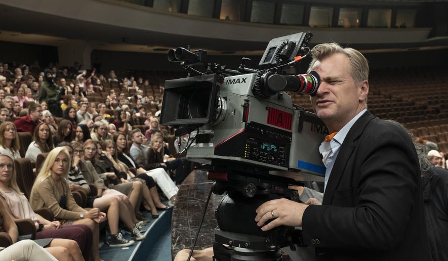 This image released by Warner Bros. Entertainment shows director Christopher Nolan during the filming of "Tenet." On Tuesday, audiences will finally be able to watch, re-watch and dissect the palindromic spy thriller starring John David Washington, Robert Pattinson and Elizabeth Debicki from the comfort of their home. The film will be available on 4K, DVD, Blu-ray and digital with behind the scenes extras that give a peek into the mind-bogglingly complex process of shooting a large-scale action film. (Melinda Sue Gordon/Warner Bros. Entertainment via AP)