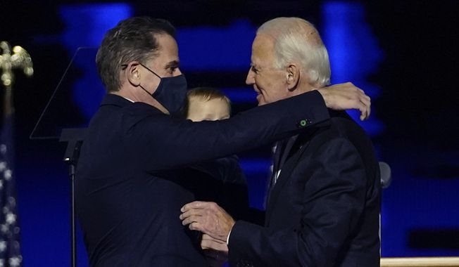 In this Nov. 7, 2020, file photo, President-elect Joe Biden, right, embraces his son Hunter Biden, left, in Wilmington, Del. Biden’s son Hunter says he has learned from federal prosecutors that his tax affairs are under investigation.  (AP Photo/Andrew Harnik, Pool)