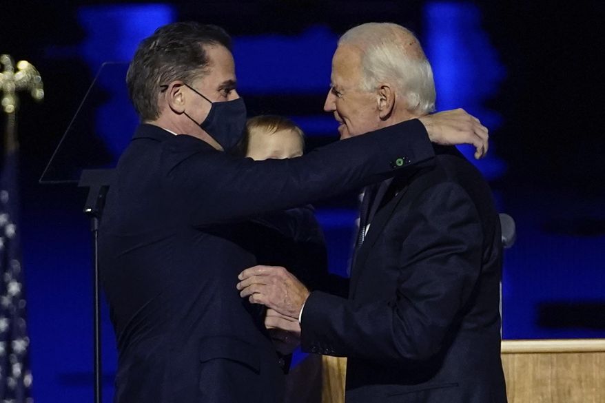 In this Nov. 7, 2020, file photo, President-elect Joe Biden, right, embraces his son Hunter Biden, left, in Wilmington, Del. Biden’s son Hunter says he has learned from federal prosecutors that his tax affairs are under investigation.  (AP Photo/Andrew Harnik, Pool)