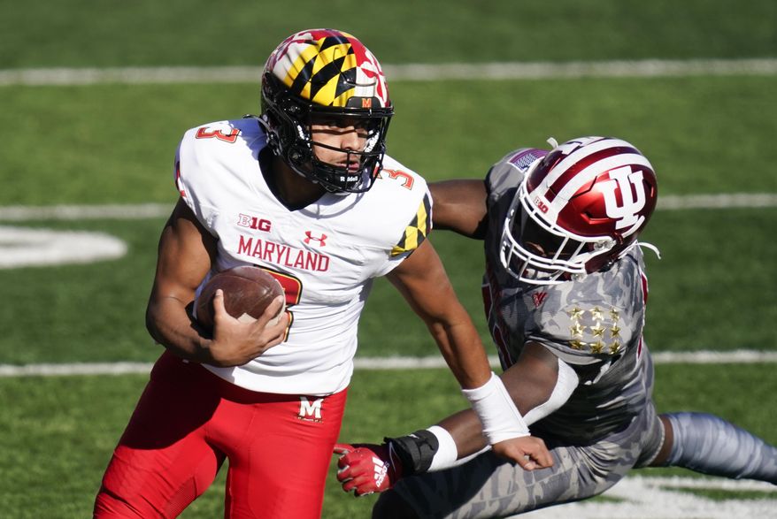 Maryland quarterback Taulia Tagovailoa (3) runs past Indiana's D.K. Bonhomme (42) during the first half of an NCAA college football game, Saturday, Nov. 28, 2020, in Bloomington, Ind. (AP Photo/Darron Cummings) **FILE**