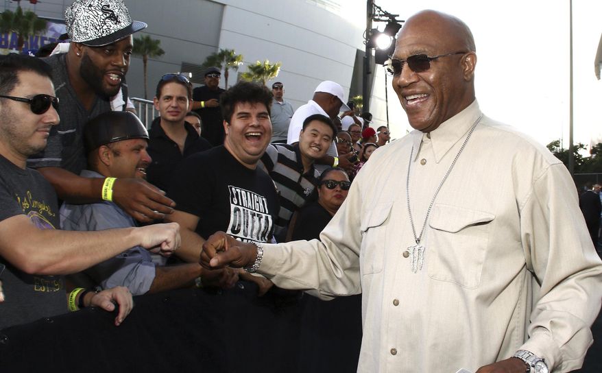 FILE - In this Monday, Aug. 10, 2015 file photo, Tommy 'Tiny' Lister greets fans as he arrives at the Los Angeles premiere of "Straight Outta Compton" at the Microsoft Theater. Tommy “Tiny” Lister, a former wrestler who was known for his Deebo character in the “Friday” films, has died. He was 62. Lister manager, Cindy Cowan, said Lister was found unconscious in his home in Marina Del Rey, California, on Thursday, Dec. 10, 2020. He was pronounced dead at the scene.  (Photo by John Salangsang/Invision/AP, File)