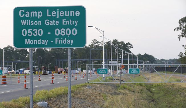 FILE - In this July 31, 2014 file photo, traffic moves onto Camp Lejeune in Jacksonville, N.C.  as access to via the now open Wilson Gate goes into effect.   Jordan Duncan, a former U.S. Marine will remain in custody after being charged with plotting to illegally make and sell guns.  Duncan was stationed at Camp Lejeune in North Carolina. He moved to Boise, Idaho, in September 2020 and was arrested by the FBI the following month. He now awaits trial and remains in federal custody. (John Althouse/The Daily News via AP)