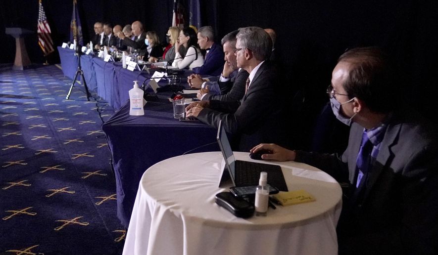FILE - In this Wednesday, Nov. 25, 2020 file photo a half-dozen adamantly maskless GOP state representatives attend a Senate Republican committee hearing to consider Rudy Giuliani’s efforts to overturn the presidential election in Gettysburg, Pa. Some Democrats in the state House want maskless Republicans to be sworn in last next month in the state Capitol, to limit the chances those lawmakers will infect others with COVID-19. (AP Photo/Julio Cortez, File)
