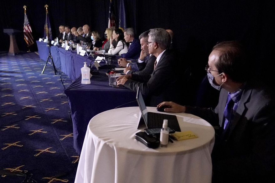 FILE - In this Wednesday, Nov. 25, 2020 file photo a half-dozen adamantly maskless GOP state representatives attend a Senate Republican committee hearing to consider Rudy Giuliani’s efforts to overturn the presidential election in Gettysburg, Pa. Some Democrats in the state House want maskless Republicans to be sworn in last next month in the state Capitol, to limit the chances those lawmakers will infect others with COVID-19. (AP Photo/Julio Cortez, File)