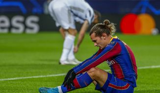 Barcelona&#39;s Antoine Griezmann reacts after missing a chance during the Champions League group G soccer match between FC Barcelona and Juventus at the Camp Nou stadium in Barcelona, Spain, Tuesday, Dec. 8, 2020. (AP Photo/Joan Monfort)