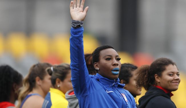 In this Aug. 10, 2019, file photo, Gwen Berry of the United States waves as she is introduced at the start of the women&#x27;s hammer throw final during athletics competition at the Pan American Games in Lima, Peru. In the summer of 2019, U.S Olympic and Paralympic Committee CEO Sarah Hirshland reprimanded Berry and fencer Race Imboden for violating Rule 50, which prohibits inside-the-lines protests at the games, after Berry raised her fist and Imboden kneeled on the medals stand at the Pan-Am Games in Peru. (AP Photo/Rebecca Blackwell, File)  **FILE**