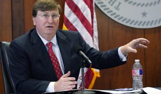 Mississippi Gov. Tate Reeves responds to questions regarding the holiday social receptions his office planned at the Governor&#39;s Mansion, during his covid news briefing, Wednesday, Dec. 9, 2020 in Jackson, Miss. (AP Photo/Rogelio V. Solis)
