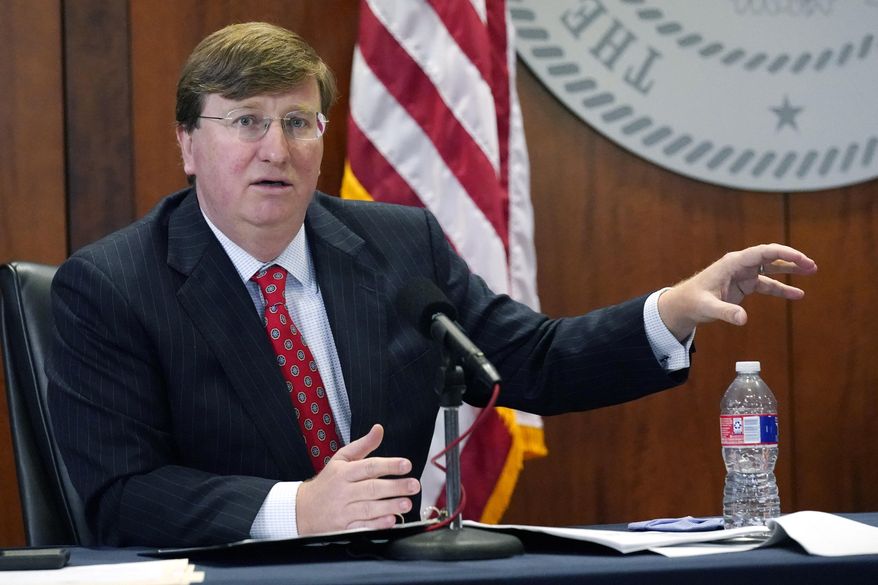 Mississippi Gov. Tate Reeves responds to questions regarding the holiday social receptions his office planned at the Governor&#x27;s Mansion, during his covid news briefing, Wednesday, Dec. 9, 2020 in Jackson, Miss. (AP Photo/Rogelio V. Solis)