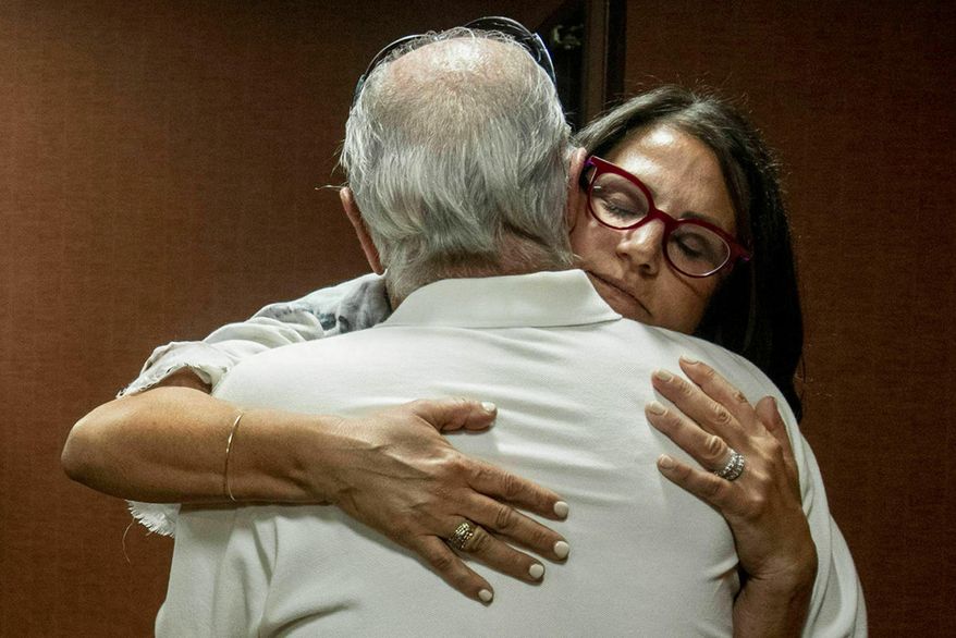 FILE - In this July 11, 2019 file photo, Tanya Gersh, a Montana real estate agent, embraces her father Lloyd Rosenstein following a hearing at the Russell Smith Federal Courthouse in Missoula. Mont. A Montana real estate agent who secured a $14 million judgment against a neo-Nazi website operator for orchestrating an anti-Semitic harassment campaign against her Jewish family is seeking a court order compelling the man to disclose information about his assets and finances. Tanya Gersh&#x27;s attorneys said in a court filing Friday, Dec. 11, 2020 that The Daily Stormer founder Andrew Anglin hasn&#x27;t paid any portion of the August 2019 judgment and has ignored their requests for information about his current whereabouts, his operation of the website and other assets. (Ben Allen/The Missoulian via AP, File)