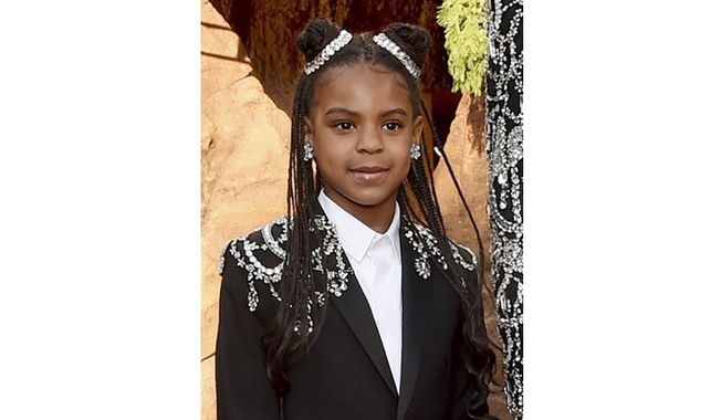 FILE - In this July 9, 2019 file photo, Beyonce, right, and her daughter Blue Ivy Carter arrive at the world premiere of "The Lion King" at the Dolby Theatre in Los Angeles. When the Recording Academy announced the nominees for the 2021 Grammys last month, Beyoncé scored a nomination for best music video for “Brown Skin Girl," which Ivy Carter is credited as a featured artist. The eight-year-old's name did not appear on the nominees list, but the Grammys recently updated its website to now include her. (Photo by Chris Pizzello/Invision/AP, File)