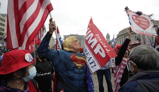 Supporters of President Donald Trump attend a rally at Freedom Plaza, Saturday, Dec. 12, 2020, in Washington. (AP Photo/Luis M. Alvarez) **FILE**