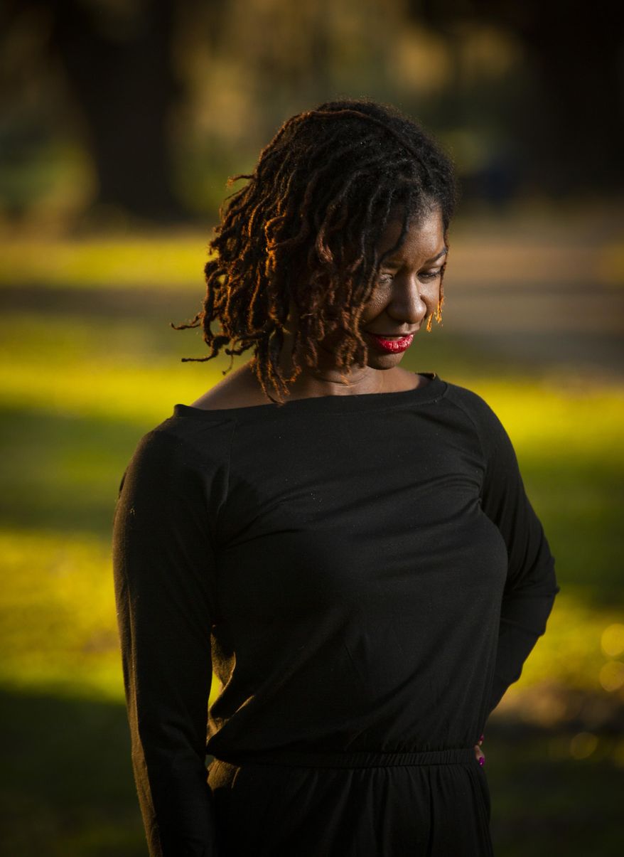 Nia Weeks poses at City Park in New Orleans, Wednesday, Dec. 9, 2020. Weeks recently appeared before a City Council committee and requested that members approve a local version of what’s know as the CROWN Act, a measure banning discrimination against hair styles commonly worn by members of a particular race. The ordinance, approved unanimously in the Community Development Committee, was modeled on the federal legislation. The bill passed the U.S. House in September. (Sophia Germer/The Times-Picayune/The New Orleans Advocate via AP)