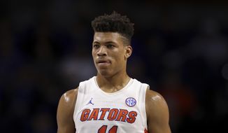 In this Nov. 29, 2019, file photo, Florida forward Keyontae Johnson (11) looks on during during the first half of an NCAA college basketball game against Marshall in Gainesville, Fla.  Johnson, the Southeastern Conference&#39;s preseason player of the year, collapsed coming out of a timeout against rival Florida State and needed emergency medical attention Saturday, Dec. 1`2, 2020. He was taken off the floor on a stretcher and rushed to Tallahassee Memorial for evaluation. The Gators had no immediate update on his condition. (AP Photo/Matt Stamey, File) **FILE**