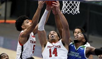 Texas Tech guard Micah Peavy (5) and forward Marcus Santos-Silva (14) go after a rebound with Texas A&amp;amp;M-CC  guard Myles Smith (2) in the first half of an NCAA college basketball game in Frisco, Texas, Saturday, Dec. 12, 2020. (AP Photo/Matt Strasen)