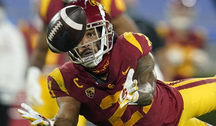 Southern California safety Isaiah Pola-Mao (21) catches an interception during the second quarter of an NCAA college football game against UCLA, Saturday, Dec. 12, 2020, in Pasadena, Calif. (AP Photo/Ashley Landis)