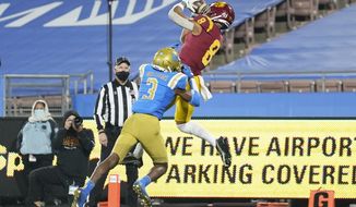 Southern California wide receiver Amon-Ra St. Brown (8) catches a pass in the end zone for a touchdown while defended by UCLA defensive back Rayshad Williams (3) during the fourth quarter of an NCAA college football game Saturday, Dec 12, 2020, in Pasadena, Calif. (AP Photo/Ashley Landis)