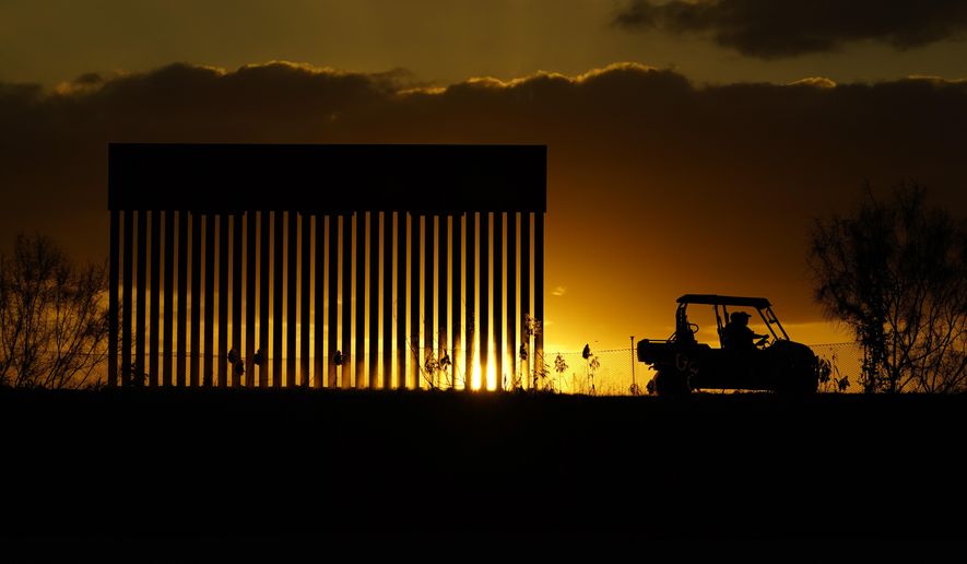 Authorities pass a border wall construction site, in Mission, Texas, Monday, Nov. 16, 2020. President-elect Joe Biden will face immediate pressure to fulfill his pledge to stop border wall construction. But he will confront a series of tough choices left behind by President Donald Trump, who&#x27;s ramped up construction in his final weeks. (AP Photo/Eric Gay)