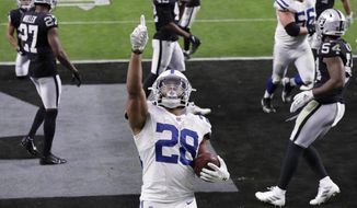 Indianapolis Colts running back Jonathan Taylor (28) celebrates after scoring a touchdown against the Las Vegas Raiders during the second half of an NFL football game, Sunday, Dec. 13, 2020, in Las Vegas. (AP Photo/Isaac Brekken)