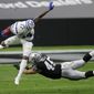 Indianapolis Colts cornerback Isaiah Rodgers (34) jumps over Las Vegas Raiders fullback Alec Ingold (45) during the first half of an NFL football game, Sunday, Dec. 13, 2020, in Las Vegas. (AP Photo/Isaac Brekken)